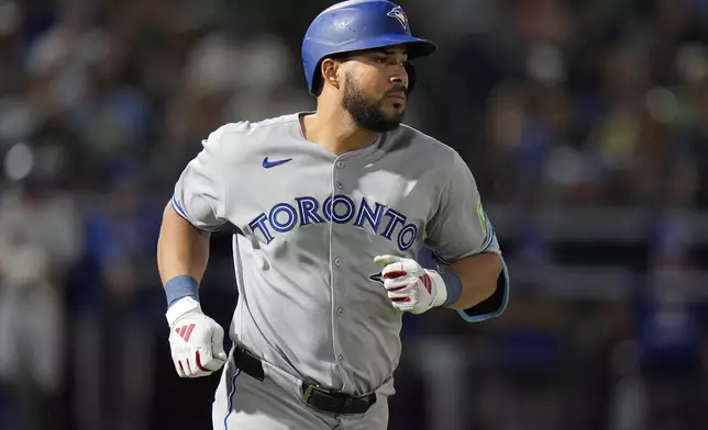 Toronto Blue Jays' Anthony Santander runs to first base after his single off Tampa Bay Rays pitcher Garrett Cleavinger during the sixth inning of a baseball game Saturday, May 24, 2025, in Tampa, Fla. (AP Photo/Chris O'Meara)
