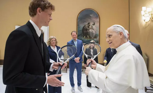 Italy's Jannik Sinner, left, shares a light moment with Pope Leo XIV on the occasion of their meeting at the Vatican, Wednesday, May 14, 2025. (Vatican Media via AP)