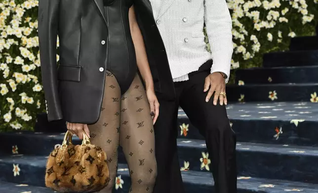 Helen Lasichanh, left, and Pharrell Williams attend The Metropolitan Museum of Art's Costume Institute benefit gala celebrating the opening of the "Superfine: Tailoring Black Style" exhibition on Monday, May 5, 2025, in New York. (Photo by Evan Agostini/Invision/AP)