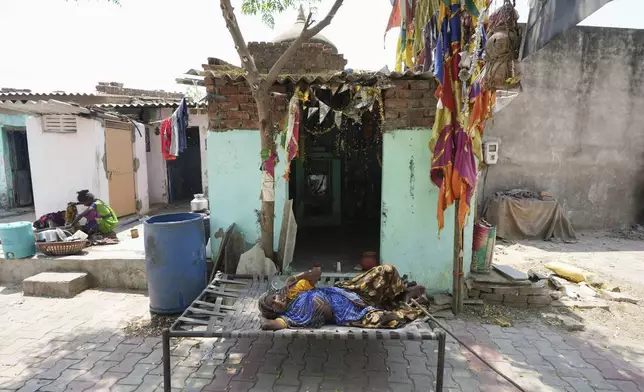 An elderly woman rest in the shade of a tree in Ahmedabad, India, Wednesday, April 2, 2025. (AP Photo/Ajit Solanki)