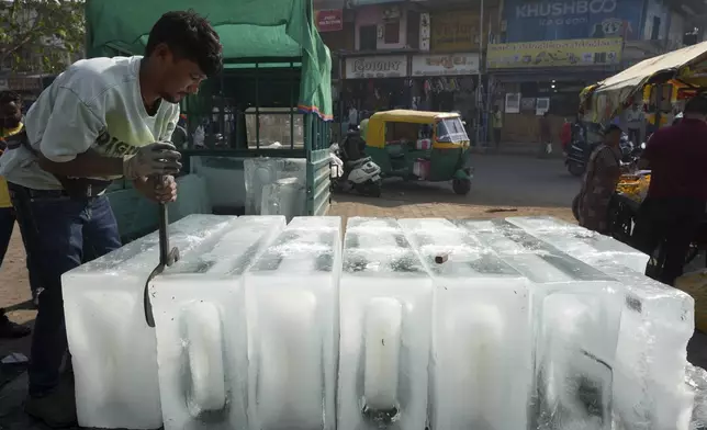 A man arranges ice blocks to sell at his stall in Ahmedabad, India, Wednesday, April 2, 2025. (AP Photo/Ajit Solanki)