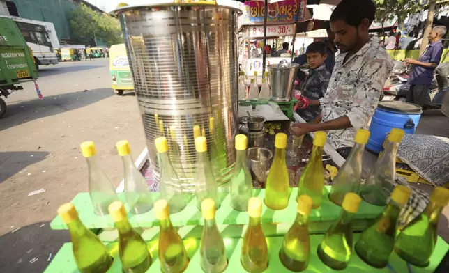 Mukesh Patni makes lime juice at his stall in Ahmedabad, India, Wednesday, April 2, 2025. (AP Photo/Ajit Solanki)