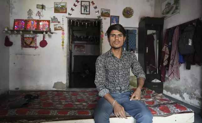 Veer Vanzara sits inside his house with reflective paint on the roof that helps keep the indoors cooler in Ahmedabad, India, Wednesday, April 2, 2025. (AP Photo/Ajit Solanki)