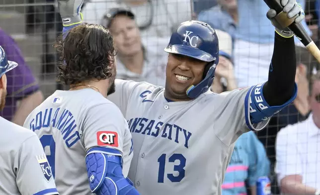 Kansas City Royals' Vinnie Pasquantino and catcher Salvador Perez (13) celebrate Pasquantino's two-run home run during the first inning of a baseball game against the Tampa Bay Rays, Wednesday, April 30, 2025, in Tampa, Fla. (AP Photo/Jason Behnken)
