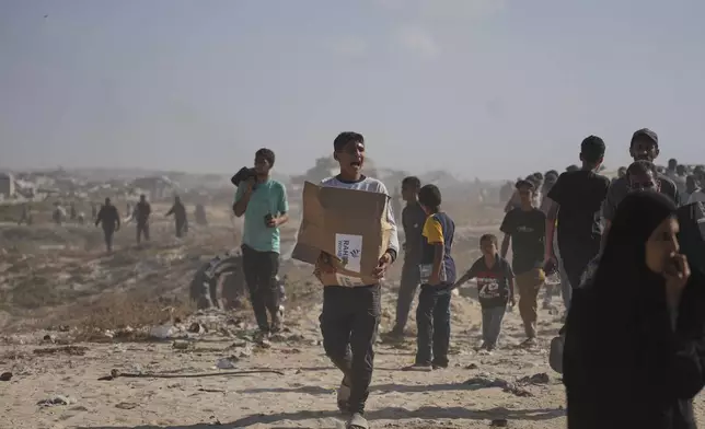Palestinians carry boxes containing food and humanitarian aid packages delivered by the Gaza Humanitarian Foundation, a U.S.-backed organization approved by Israel, in Rafah, southern Gaza Strip, on Tuesday, May 27, 2025. (AP Photo/Abdel Kareem Hana)