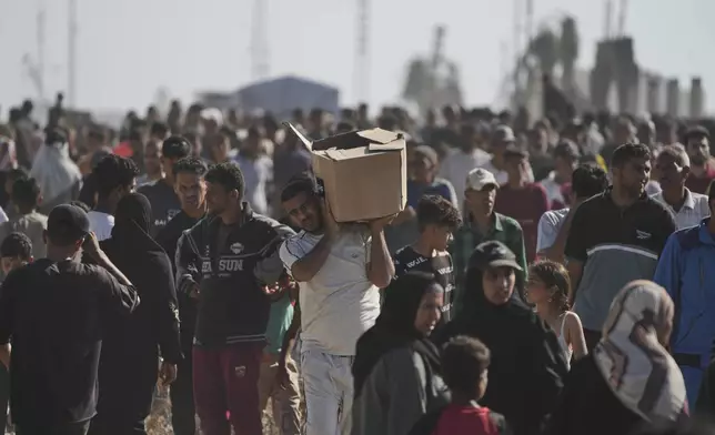 Palestinians carry boxes containing food and humanitarian aid packages delivered by the Gaza Humanitarian Foundation, a U.S.-backed organization approved by Israel, in Rafah, southern Gaza Strip, on Tuesday, May 27, 2025. (AP Photo/Abdel Kareem Hana)