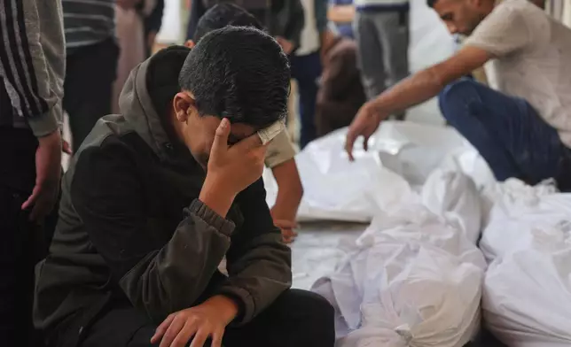 Palestinians mourn their relatives who were killed in an Israeli army airstrike on the Gaza Strip, at the Al-Aqsa Hospital in Deir al-Balah, Gaza, Wednesday, May 28, 2025. (AP Photo/Abdel Kareem Hana)