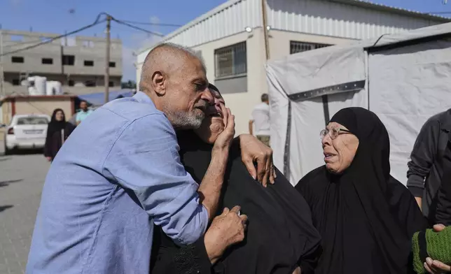 Palestinians mourn during the funeral of their relatives who were killed in an Israeli army airstrike on the Gaza Strip, at the Al-Aqsa Hospital in Deir al-Balah, Gaza, Wednesday, May 28, 2025. (AP Photo/Abdel Kareem Hana)