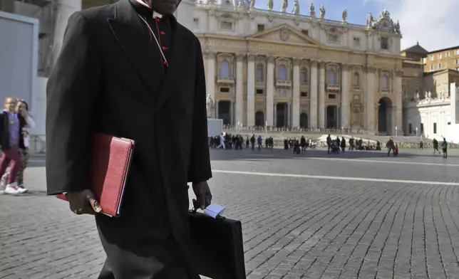 FILE - In this March 4, 2013 file photo, Cardinal Robert Sarah, of Guinea, walks in St. Peter's Square after attending a cardinals' meeting, at the Vatican. (AP Photo/Andrew Medichini, File)
