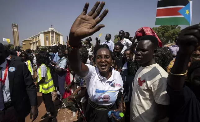 FILE - People in the crowd cheer and wave as Pope Francis is wheeled past after addressing clergy at the St. Theresa Cathedral in Juba, South Sudan, Saturday, Feb. 4, 2023. (AP Photo/Ben Curtis, File)