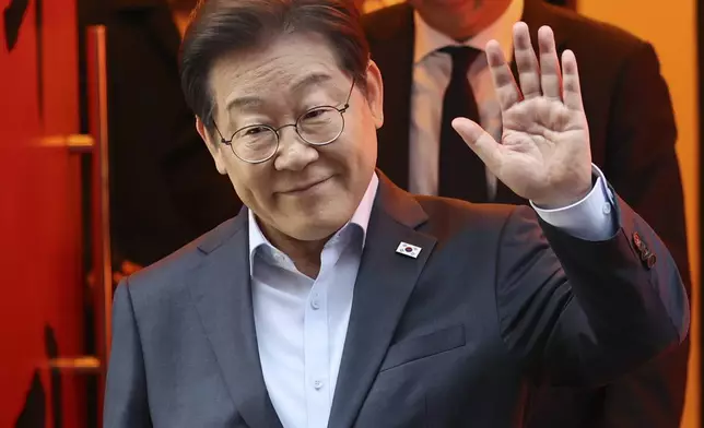 South Korea's Democratic Party presidential candidate Lee Jae-myung exits a meeting with delivery workers in Seoul, South Korea, Thursday, May 1, 2025. (Suh Myung-geon/Yonhap via AP)