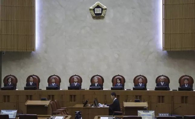 South Korea's Supreme Court Chief Justice Cho Hee-dae, center, and other justices are seated in the courtroom to attend a hearing to hand down a ruling on the election law violation case of the Democratic Party presidential candidate Lee Jae-myung in Seoul, South Korea, Thursday, May 1, 2025. (Yonhap via AP)