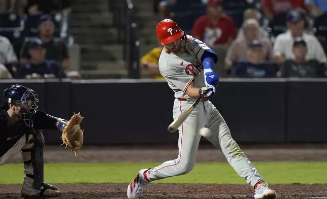 Philadelphia Phillies' Trea Turner connects for an RBI single off Tampa Bay Rays pitcher Manuel Rodríguez during the 10th inning of a baseball game Thursday, May 8, 2025, in Tampa, Fla. (AP Photo/Chris O'Meara)