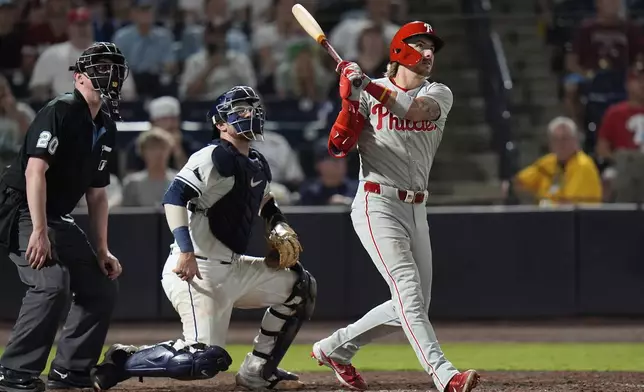 Philadelphia Phillies' Bryson Stott, right, watches his three-run home run off Tampa Bay Rays pitcher Edwin Uceta during the eighth inning of a baseball game Thursday, May 8, 2025, in Tampa, Fla. (AP Photo/Chris O'Meara)