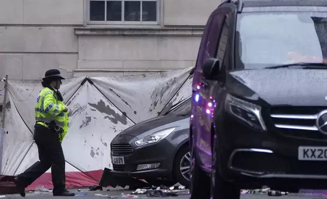 Police and emergency personnel deal with an incident near the Liver Building during the Premier League winners parade in Liverpool, England, Monday, May 26, 2025.(AP Photo/Jon Super)
