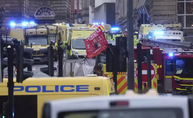 Police and emergency personnel deal with an incident near the Liver Building during the Premier League winners parade in Liverpool, England, Monday, May 26, 2025.(AP Photo/Jon Super)