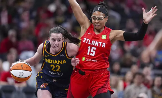 Indiana Fever guard Caitlin Clark (22) drives around Atlanta Dream guard Allisha Gray (15) in the first half of a WNBA basketball game in Indianapolis, Tuesday, May 20, 2025. (AP Photo/Michael Conroy)