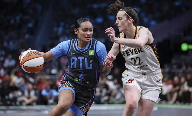 Atlanta Dream guard Te-Hina Paopao (2) drives to the basket against Indiana Fever guard Caitlin Clark (22) in the second half of an WNBA basketball game, Thursday, May, 22, 2025, in Atlanta. (AP Photo/Colin Hubbard)