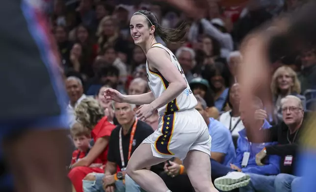 Indiana Fever guard Caitlin Clark reacts after making a three-pointer in the first half of an WNBA basketball game against the Atlanta Dream, Thursday, May, 22, 2025, in Atlanta. (AP Photo/Colin Hubbard)
