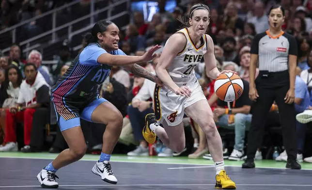 Indiana Fever guard Caitlin Clark (22) drives to the basket against Atlanta Dream guard Te-Hina Paopao, left, in the first half of an WNBA basketball game, Thursday, May, 22, 2025, in Atlanta. (AP Photo/Colin Hubbard)