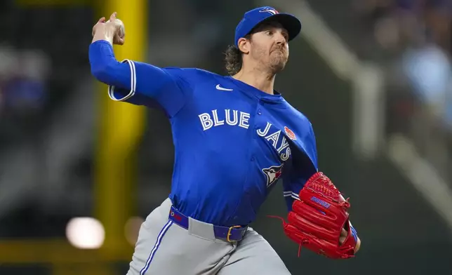 Toronto Blue Jays starting pitcher Kevin Gausman throws a pitch to the Texas Rangers during the first inning of a baseball game, Monday, May 26, 2025, in Arlington, Texas. (AP Photo/Julio Cortez)