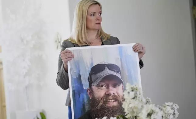 Stacey Wales, sister of the late Christopher Pelkey, displays her brother's image at her mother's home, Wednesday, May 7, 2025, in Chandler, Ariz. (AP Photo/Matt York)