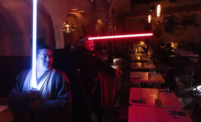 Star Wars fans gather at Nowan's Cantina, in Santiago, Chile, Saturday, May 3, 2025, on the eve of May 4th, known as Star Wars Day, when fans of the franchise get to greet others with "May the Fourth be with you" in a nod to the classic movie line, "May the force be with you. (AP Photo/Matias Basualdo)