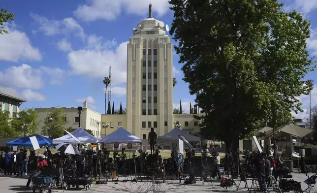 Media stage outside the Van Nuys Courthouse for a hearing in the case of Erik and Lyle Menendez Tuesday, May 13, 2025, in Los Angeles. (AP Photo/Damian Dovarganes)