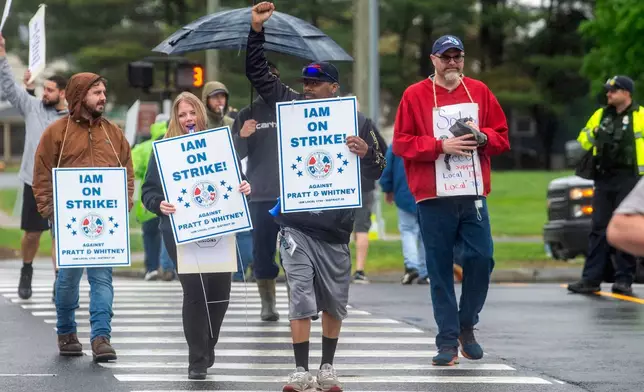 Pratt &amp; Whitney employees hold signs while picketing at the Silver Lane entrance in East Hartford, Conn., on the first day of their strike, Monday, May 5, 2025. (Aaron Flaum/Hartford Courant via AP)