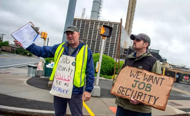 Pratt &amp; Whitney employees hold signs while picketing at the Main Street entrance in East Hartford, Conn., on the first day of their strike, Monday, May 5, 2025. (Aaron Flaum/Hartford Courant via AP)
