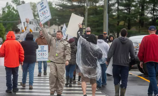 Pratt &amp; Whitney employees hold signs while picketing at the Silver Lane entrance in East Hartford, Conn., on the first day of their strike, Monday, May 5, 2025. (Aaron Flaum/Hartford Courant via AP)