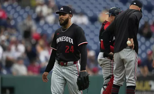 Minnesota Twins starting pitcher Simeon Woods Richardson is taken out of the game in the fifth inning of a baseball game against the Cleveland Guardians in Cleveland, Thursday, May 1, 2025. (AP Photo/Sue Ogrocki)
