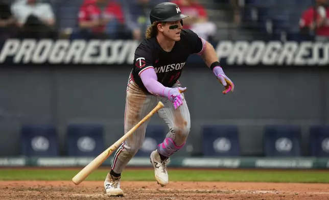 Minnesota Twins' Harrison Bader doubles in the eighth inning of a baseball game against the Cleveland Guardians in Cleveland, Thursday, May 1, 2025. (AP Photo/Sue Ogrocki)