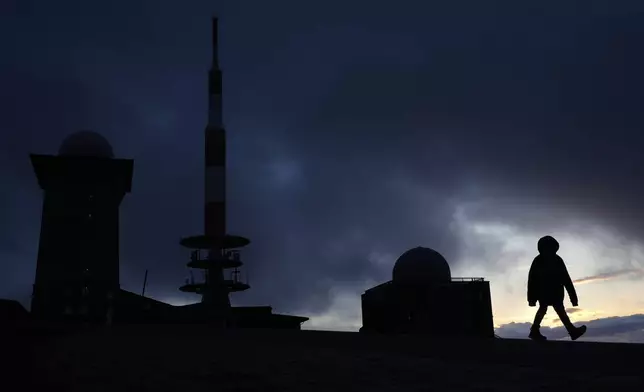 A boy leaves the summit of the 1,142-meter (3,743 feet) high Brocken mountain in the Harz forest near Schierke, Germany, Friday, May 23, 2025. (AP Photo/Matthias Schrader)