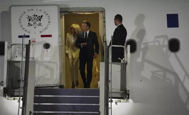 French President Emmanuel Macron and his wife Brigitte Macron disembark an aircraft upon arrival in Jakarta, Indonesia, Tuesday, May 27, 2025. (AP Photo/Achmad Ibrahim)