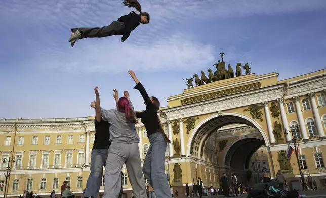 Youths practice their skills in cheerleading outside Palace Square in St. Petersburg, Russia, Tuesday, May 27, 2025. (AP Photo/Dmitri Lovetsky)