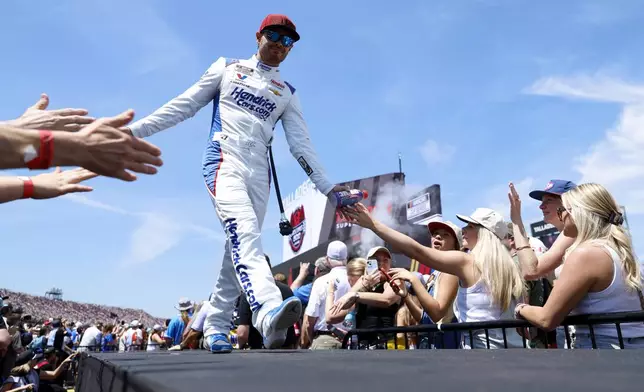 NASCAR Cup Series driver Kyle Larson greets fans before a NASCAR Cup Series auto race at Talladega Superspeedway, Sunday, April 27, 2025, in Talladega, Ala. (AP Photo/Butch Dill)