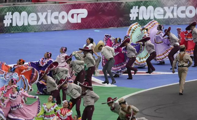 FILE - Dancers perform during a drivers parade before the Formula One Mexico Grand Prix auto race at the Hermanos Rodriguez racetrack in Mexico City, Oct. 27, 2024. (AP Photo/Eduardo Verdugo, File)