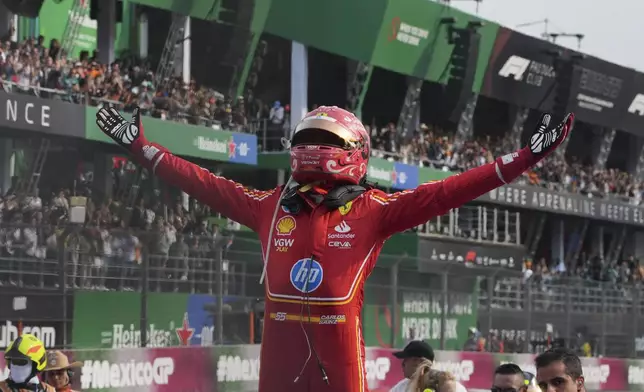 FILE - Ferrari driver Carlos Sainz of Spain celebrates after winning the Formula One Mexico Grand Prix auto race at the Hermanos Rodriguez racetrack in Mexico City, Oct. 27, 2024. (AP Photo/Fernando Llano, File)
