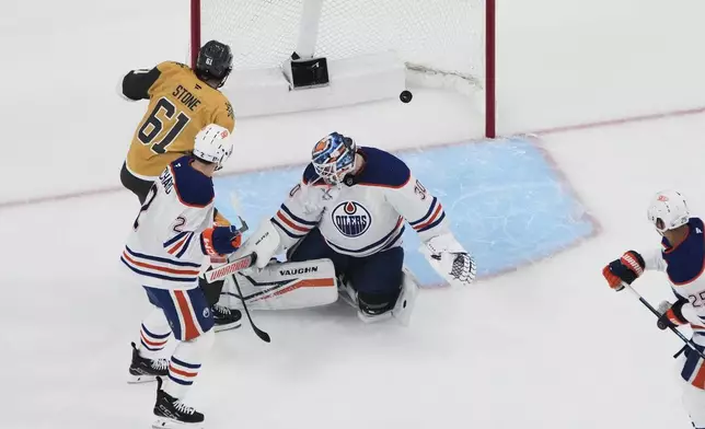 Vegas Golden Knights right wing Mark Stone (61) scores against Edmonton Oilers goaltender Calvin Pickard (30) during the first period of Game 1 of a second-round NHL hockey playoff series Tuesday, May 6, 2025, in Las Vegas. (AP Photo/John Locher)