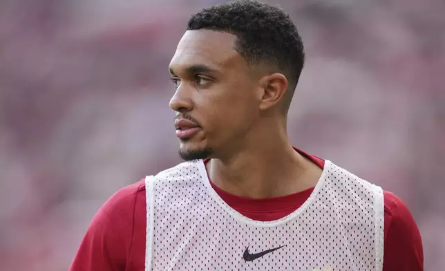 Liverpool's Trent Alexander-Arnold prepares to enter the pitch as substitute during the English Premier League soccer match between Liverpool and Arsenal, at Anfield stadium in Liverpool, England, Sunday, May 11, 2025. (AP Photo/Jon Super)