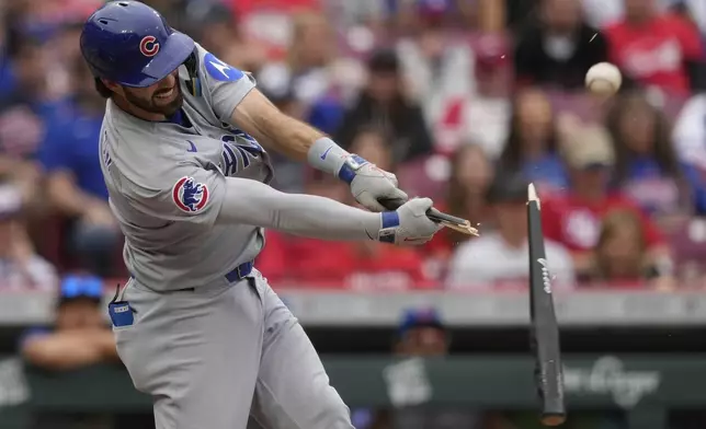 Chicago Cubs' Dansby Swanson breaks his bat as he hits a single in the seventh inning of a baseball game against the Cincinnati Reds, Sunday, May 25, 2025, in Cincinnati. (AP Photo/Carolyn Kaster)