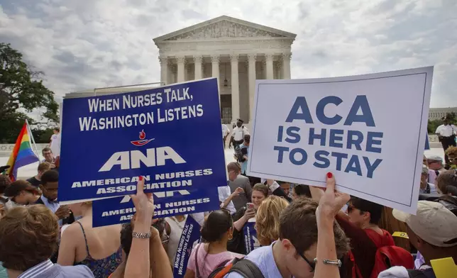 FILE - Supporters of the Affordable Care Act hold up signs as the opinion for health care is reported outside of the Supreme Court in Washington, June 25, 2015. The Supreme Court on Thursday upheld the nationwide tax subsidies under President Barack Obama's health care overhaul, in a ruling that preserves health insurance for millions of Americans. (AP Photo/Jacquelyn Martin, File)