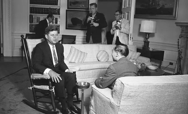 FILE - President Kennedy sits in his now famous rocking chair while talking with Nguyen Dinh Thuan, a top South Viet Nam official, at the White House in Washington on June 14, 1961. (AP Photo/Henry Burroughs, File)