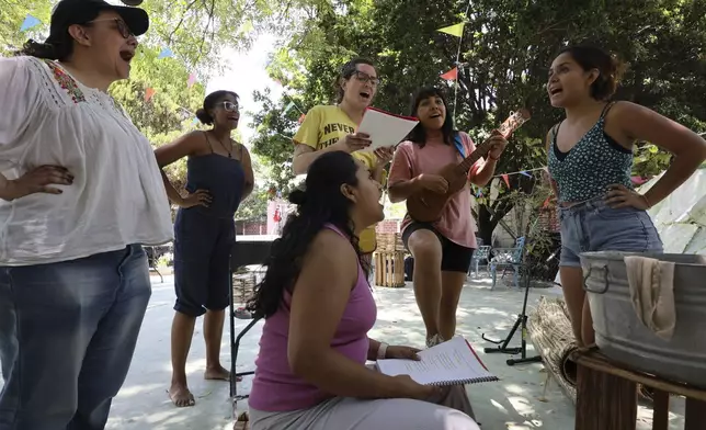 Director Paola Izquierdo, left, helps Mulato Teatro cast members harmonize their voices as they rehearse for their upcoming performance at the First International Afro-Scenic Festival, in Ticumán, Mexico, Saturday, May 17, 2025. (AP Photo/Ginnette Riquelme)