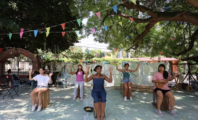 Mulato Teatro cast members from left to right, Azul Ruíz; Marlene Romero; Marisol Castillo; Caro Rodríguez and Eréndira Castorela strumming a jarana instrument, rehearse for their upcoming performance in the First International Afro-Scenic Festival, in Ticumán, Mexico, Saturday, May 17, 2025. (AP Photo/Ginnette Riquelme)