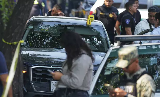 Police inspect the car where Mexico City Mayor Clara Brugada's private secretary, Ximena Guzman, and adviser, Jose Munoz, were killed in Mexico City, Tuesday, May 20, 2025. (AP Photo/Fernando Llano)