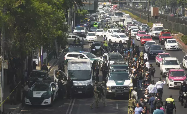 Police cordon off the area where Mexico City Mayor Clara Brugada's private secretary, Ximena Guzman, and adviser, Jose Munoz, were killed in Mexico City, Tuesday, May 20, 2025. (AP Photo/Fernando Llano)
