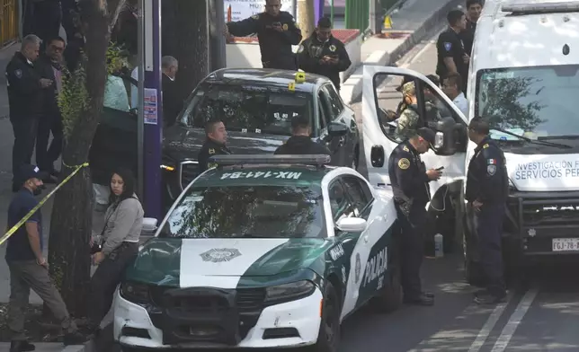 Police inspect the car where Mexico City Mayor Clara Brugada's private secretary, Ximena Guzman, and adviser, Jose Munoz, were killed in Mexico City, Tuesday, May 20, 2025. (AP Photo/Fernando Llano)