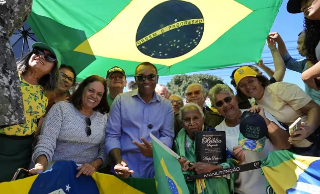 Supporters of former President Jair Bolsonaro pose for a photo in front of the hospital, before the ex-president's departure after a weeks-long surgical stay, in Brasilia, Brazil, Sunday, May 4, 2025. (AP Photo/Eraldo Peres)